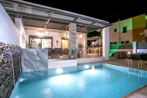 a swimming pool in the middle of a house at Kiki Luxury Villa in Afantou