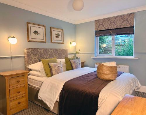a bedroom with a large bed and a window at The Emsworth in Emsworth