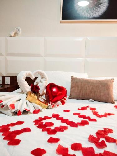 a bed with a bunch of red hearts on it at POUSADA ESTÂNCIA in Penedo