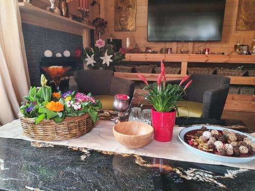 a table with flowers and baskets on top of it at Beskiden Prime Exclusiv Chalets in Prostřední Bečva