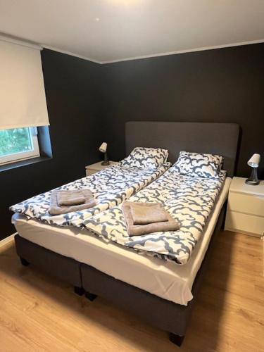 a bed with two pillows on it in a bedroom at Apartments near Bergen Airport in Bergen