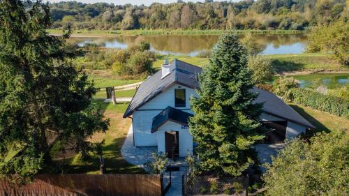 an aerial view of a house next to a lake at Tonkielek - Domek z Jacuzzi Nad Rzeką Bug in Tonkiele