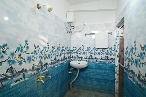 a bathroom with a painting on the wall at Gouranga Guest House Mayapur ISKCON 300 MTS in mayapur