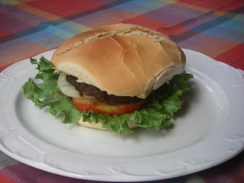 a sandwich on a white plate on a table at Sunset Bay Club & SeaSide Resort in Salisbury