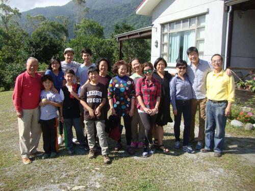 a group of people posing for a picture in front of a house at Taroko Sialin Coffee Farm Homestay in Xiulin