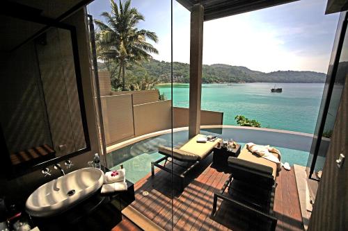 a bathroom with a view of the ocean and a bath tub at Impiana Private Villas Kata Noi in Kata Beach