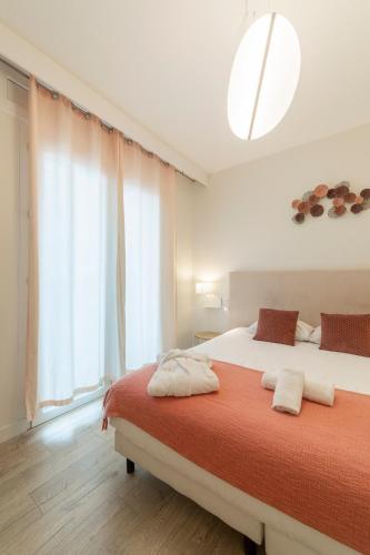 a bedroom with two beds and a large window at Cit'Hotel Imperial in Sète