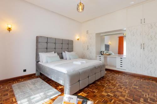 a bedroom with a large white bed in a room at Kivulini Eco Park Karen in Nairobi