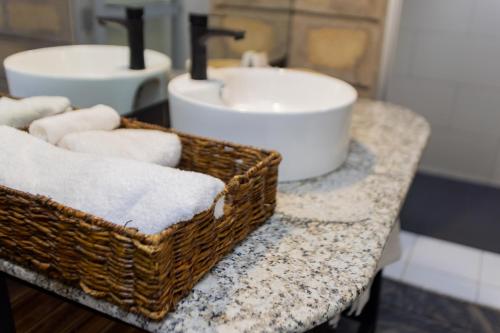 a bathroom with two baskets of towels and a sink at Kivulini Eco Park Karen in Nairobi
