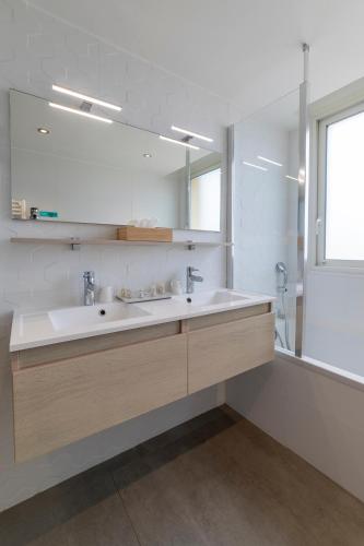 a bathroom with a sink and a mirror at Cit'Hotel Imperial in Sète
