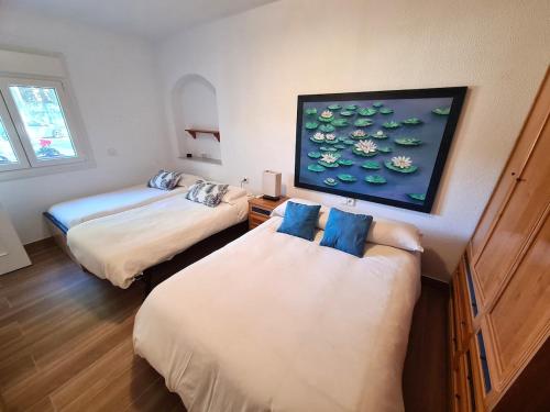 a room with two beds and a tv on the wall at Villa Serena - Casa rural en Arcos con piscina, barbacoa, chimenea in Arcos de la Frontera