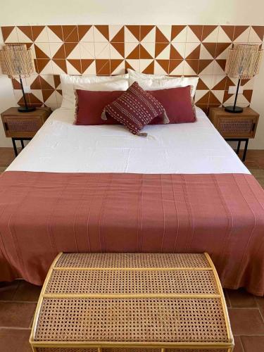 a large bed with two pillows and two lamps at Rustic House with 2 Pools in a Monastery in Tavira