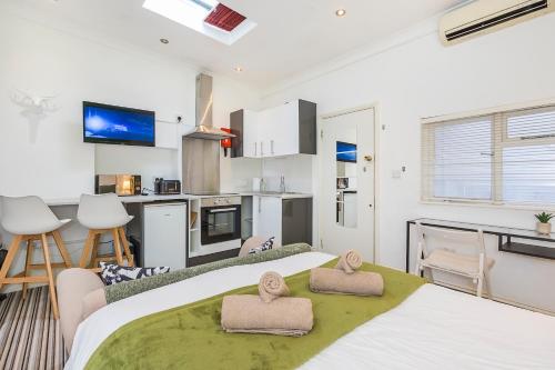 a bedroom with a large bed with two towels at Islington Quarter in London