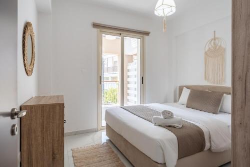a bedroom with a large bed and a window at Infinity - One-Bedroom Apt W Terrace in Larnaca in Larnaca