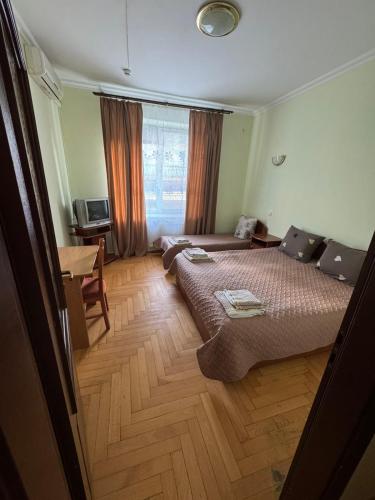 a hotel room with a bed and a table at Готель "Український Дворик" in Lviv