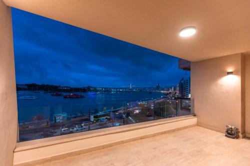 a room with a window with a view of the water at Galileo - Sliema Seafront Luxury Apartment in Sliema