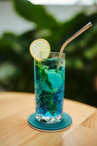 a drink with a lemon slice in a glass on a table at Kondey Villas in Kondey