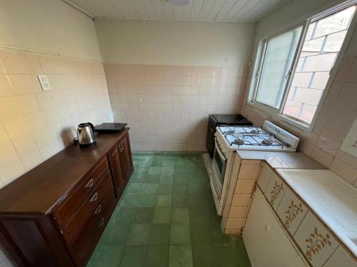 查斯科穆斯Casa a dos cuadras de la laguna的一个带炉灶和窗户的空厨房