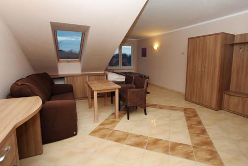 a living room with a couch and a table at Apartamenty Rok in Kołobrzeg