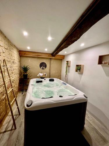 d'une grande baignoire installée dans une pièce avec dans l'établissement Charming house for 14 pool and indoor hottub, à Mauzac-et-Grand-Castang