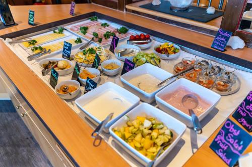a buffet line with different types of food at Mercure Salzburg City in Salzburg