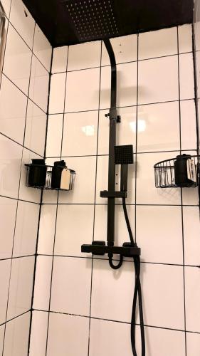 a room with three lights on a white tiled wall at Free Parking! Kingston Studio, ideal for professionals relocators and leisure stays, near Kingston Station and Shopping Centre in Kingston upon Thames