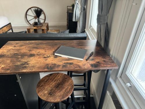 a table in a room with a laptop and stool at Kingston Studio, ideal for professionals relocators and leisure stays, near Kingston Station and Shopping Centre in Kingston upon Thames