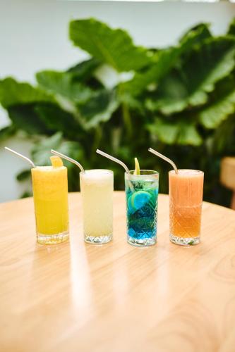 a group of four different colored glasses sitting on a table at Kondey Villas in Kondey