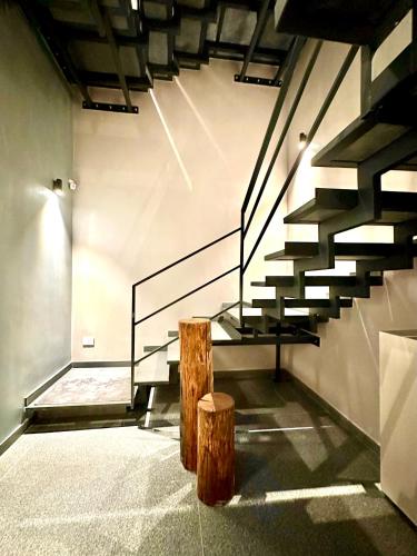 a set of stairs in a room with two logs at Villa AYA in Riposto