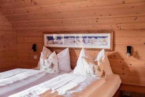 a bedroom with two beds in a log cabin at st martin chalets in Sankt Michael im Lungau