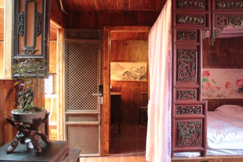 a bedroom with a bed and an open door at Xishan Wutong Qinyuan (Free Pick up Service) in Huangshan