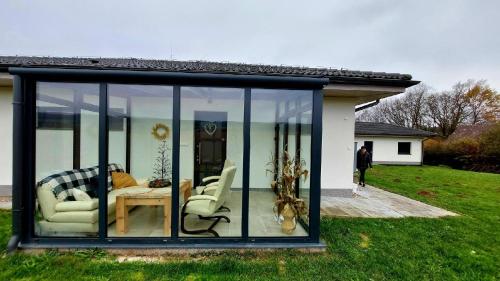 a glass house with a living room in a yard at Ubytování nad přehradou in Dvůr Králové nad Labem