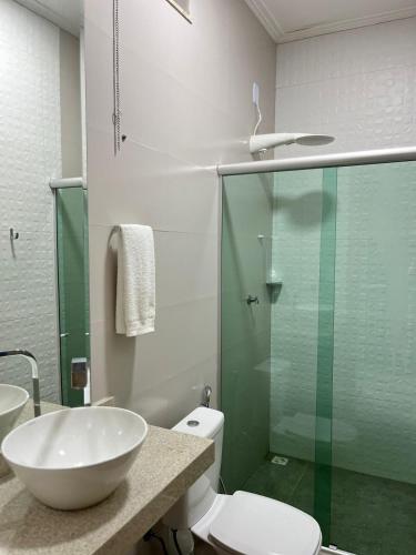 a bathroom with a sink and a toilet and a glass shower at STILLO AÇAI in Bragança