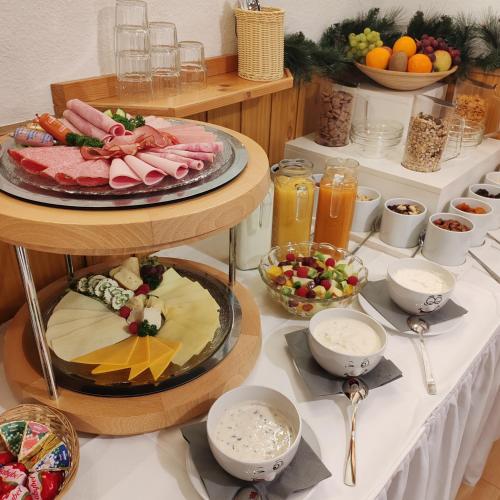 a table with a plate of food on a table at Waldhotel Unterbach in Düsseldorf