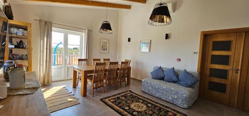 a living room with a table and a dining room at Quinta da Bornacha - Casa A in Vila Nova De Cacela