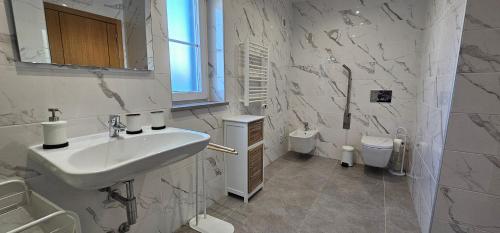 un bagno bianco con lavandino e WC di Quinta da Bornacha - Casa A a Vila Nova de Cacela