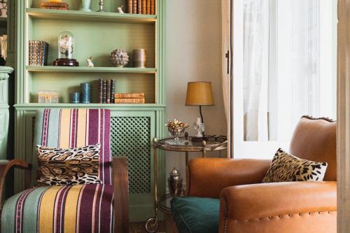 a living room with a chair and a table at Hotel Edouard VII in Biarritz