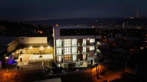 a building at night with lights on at Panorama Hills Apart-Hotel in Tbilisi City
