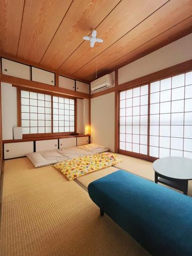 a large room with two beds and a table at 一心館 in Fukuoka