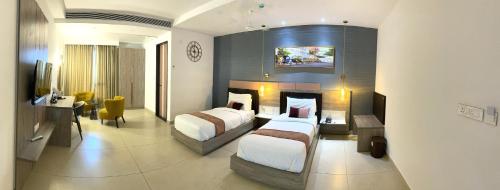 Postel nebo postele na pokoji v ubytování Le Prestige Residency