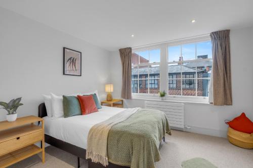 a bedroom with a bed and a large window at The Jade Suite - The Jewellery Suites, 3 bed 3 bath in Birmingham