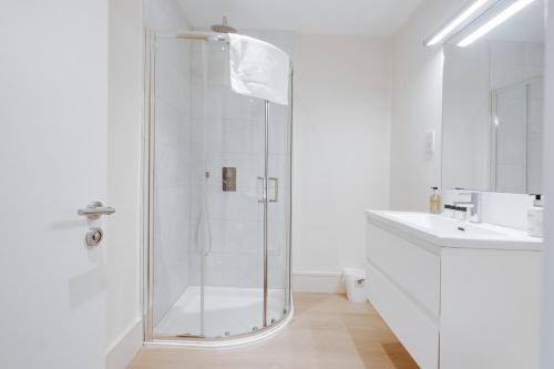 a white bathroom with a shower and a sink at The Jade Suite - The Jewellery Suites, 3 bed 3 bath in Birmingham
