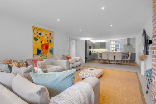 a living room with white couches and a dining room at The Jade Suite - The Jewellery Suites, 3 bed 3 bath in Birmingham