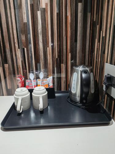 a toaster sitting on top of a black tray at Regal Inn Umhlanga Gateway in Durban