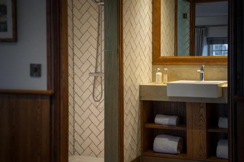 a bathroom with a sink and a mirror at The Royal Heysham in Heysham