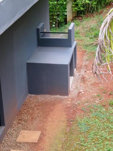 a bench sitting on the side of a building at The Executive - Exclusive Self-Catering Apartments - Ezulwini in Ezulwini