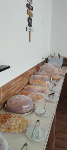 a buffet line with many different types of food at pousada beira mar suites São Bento in Maragogi