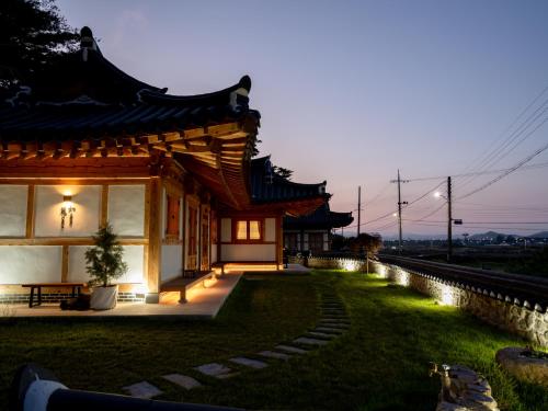 a building with a grassy yard in front of it at Hanok Stay Yeoyeo in Gyeongju