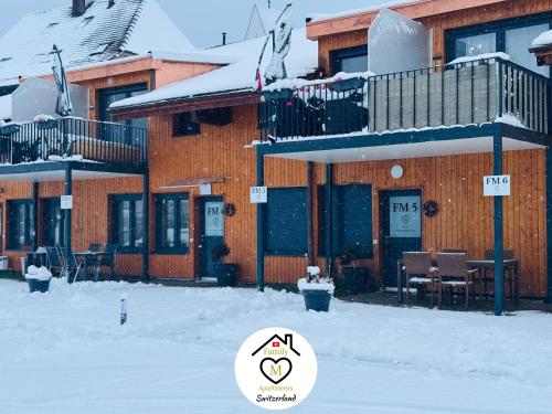a building with snow on the ground in front of it at Family M Apartments 4-5-6 in Kappel bei Olten