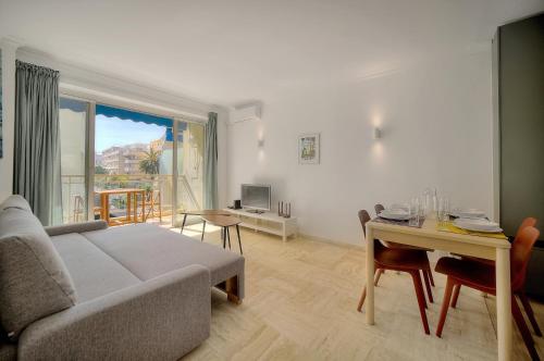 un salon avec un canapé et une table dans l'établissement Immogroom - cosy apartment - Terrace - AC - Wifi, à Cannes